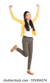 Portrait of an Asian girl arms up happy jumping around, full length standing isolated on white background. - Shutterstock ID 195304574
