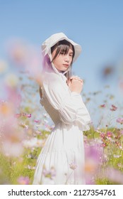 Portrait Asian Girl With Flower Bokeh In A White Dress  Cute Asian Woman In Park  Cute Asian Woman In Flower Field