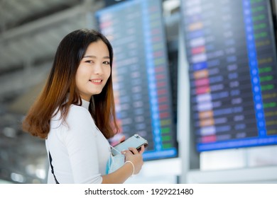 Portrait Of Asian Girl Holding Passport In The Airport