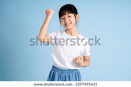 Portrait of Asian girl posing on blue background