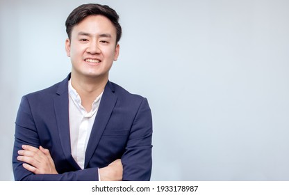 Portrait Of Asian Handsome Business Man Wearing Formal Suit, Cross His Arms And Smiling With Confident With White Background
