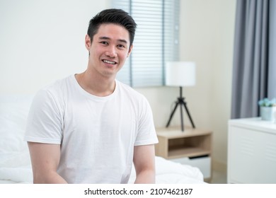 Portrait Of Asian Handsome Male In Pajamas Smile And Looking At Camera. Attractive Young Man Feeling Fresh And Happy To Wake Up Early From Bed In Bedroom In Morning At Home. Healthy Lifestyle Concept.