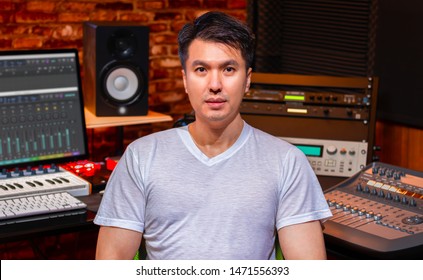 Portrait Of Asian Handsome Music Producer In Home Recording Studio