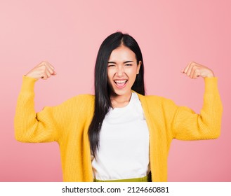 Portrait Asian Of Happy Beautiful Strong Muscles Young Woman Raises Arms Biceps Confident Showing Power And Strength Have Feeling Independent Victory Successful, Studio Shot Isolated Pink Background