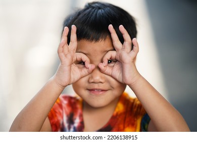 Portrait of an asian happy boy who makes funny faces - Shutterstock ID 2206138915