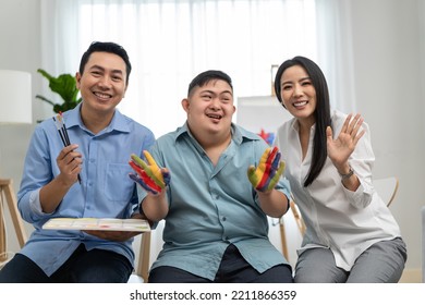 Portrait Of Asian Happy Family, Parents Draw Picture With Young Son. Beautiful Loving Couple, Mother And Father Take Care And Teach Young Man Painting Artwork Indoors And Looking At Camera In House.