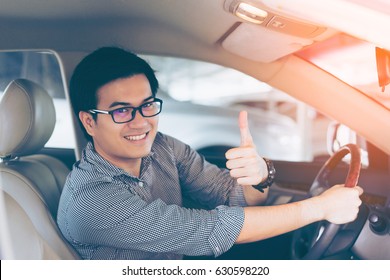 Portrait Of Asian Happy Handsome Man Showing Thumbs Up While Driving Car 