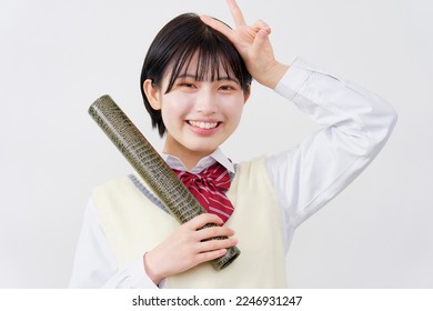 Portrait of Asian high school student with the diploma in a tube in white background