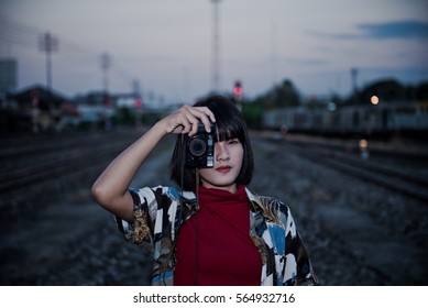 Portrait of asian hipster girl on sunset at railway vintage  style - Shutterstock ID 564932716
