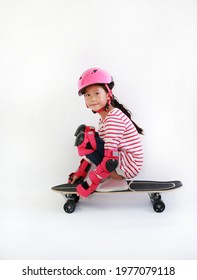 Portrait Of Asian Kid Skating On A Skateboard Isolated On White Background. Kid Riding On Skateboard