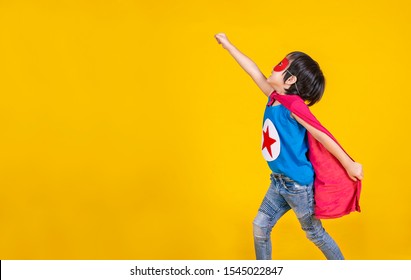 Portrait of asian little boy playing pretend to superhero. Happy young cut boy wearing hero costume, education childhood lifestyle, back to school and rescue the world in peace concept - Powered by Shutterstock