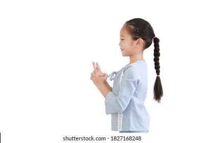 Portrait Asian Little Child Girl Expression Finger With Imaginary Gun Isolated On White Background. Kid Gesture Hand In Shape Of Gun. Side View.