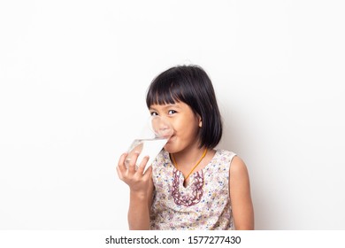 Portrait Of Asian Little Girl Drinking Water On White Blackground