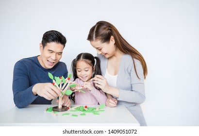 Portrait Of Asian Little Girl Playing Tree Blocks With Family Mother Father Over White Background. Learning By Playing Education Home School Concept. Parents Teaching Her Daughter To Play Blocks.