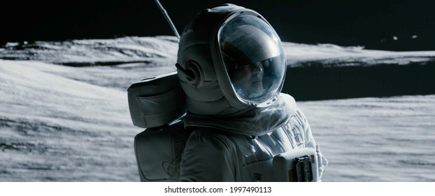 Portrait of Asian lunar astronaut opens his visor while exploring Moon surface - Shutterstock ID 1997490113