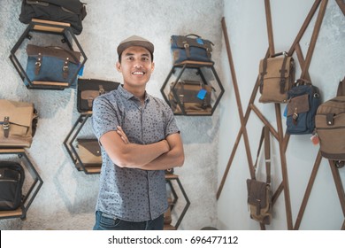 Portrait Of Asian Male Business Owner Standing In Front Of His Bag Store