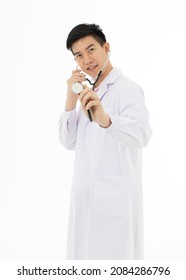 Portrait of Asian male doctor in white gown coat holding stethoscope in hand pose on white background with copy space