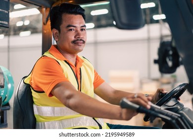 Portrait Of Asian Male Driver Driving Forklift To Shipping Delivery In The Warehouse Distribution. Import Export Logistic Career, Worker Working At Industrial Factory.