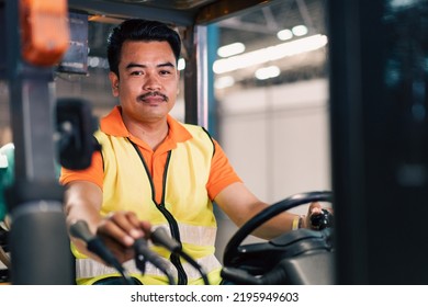 Portrait Of Asian Male Driver Driving Forklift To Shipping Delivery In The Warehouse Distribution. Import Export Logistic Career, Worker Working At Industrial Factory.