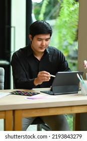 Portrait Of Asian Male Interior Designer Working Online With Digital Tablet At Modern Home Office