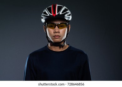 Portrait Of An Asian Man Cyclist With Helmet And Sportswear.