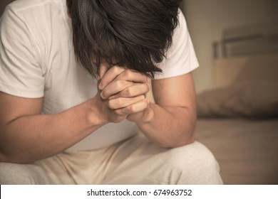 Portrait of Asian man expression in depression (man, sad, praying)