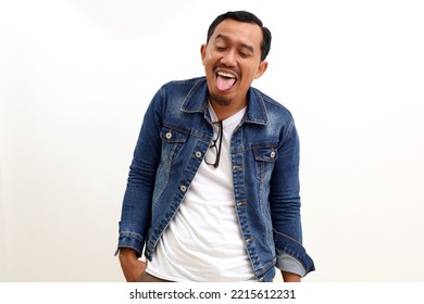 Portrait Of Asian Man With Funny Facial Expression. Sticking His Tongue Out