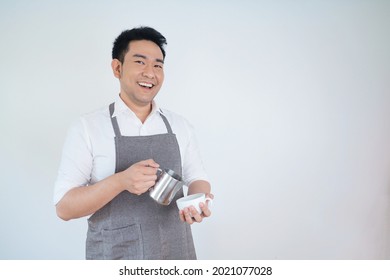 Portrait Asian man isolated on white background,Attractive barista with coffee mug isolated white background and copy space. - Powered by Shutterstock