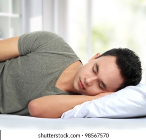 Portrait Of Asian Man Lying In Bed Sleeping