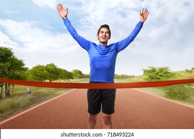 Portrait Of Asian Man Running Crossing The Finish Line On The Track Running