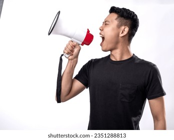 A portrait of an Asian man wearing a black shirt holding a megaphone and shouting. Isolated with a white background.