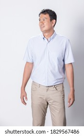 Portrait Asian Man In Wearing Blue Short Sleeve Shirt On White Background.