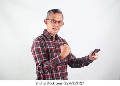 Portrait of Asian Man wearing casual shirt looks happy with the phone.
 - Shutterstock ID 2278353727