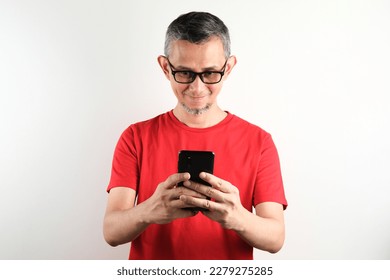 Portrait of Asian Man wearing red tshirt looks happy with the phone.
 - Shutterstock ID 2279275285