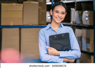 Portrait of Asian manager of worker woman standing and arm cross action in local warehouse before start her job, business and industry, business reopening after Covid19 outbreak
