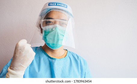 Portrait of Asian men doctor wearing PPE suit and doing acting for fighting with covid-19 pandemic outbreak. Health care workers are risking their lives to protect the lives of others. - Shutterstock ID 1783963454