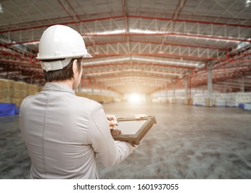 Portrait Asian Men, Staff, Product Counting Warehouse Control Manager Standing, Counting And Inspecting Products In The Warehouse ,Interior Of A Modern Warehouse ,clean And Empty