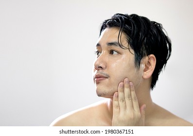 Portrait of Asian men are washing their face with foam , Men skin care concept. Beauty, people and hygiene concept. 