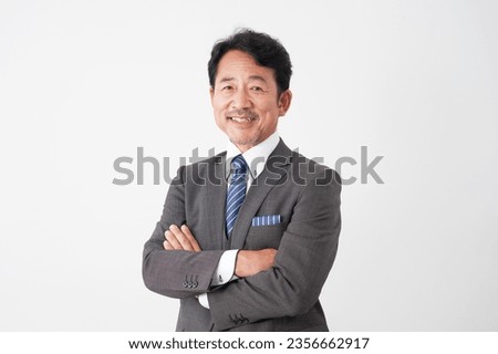 Portrait of Asian middle aged businessman smiling in whited background