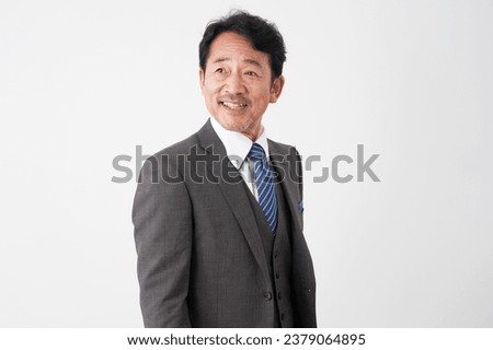 Portrait of Asian middle aged businessman smiling in white background