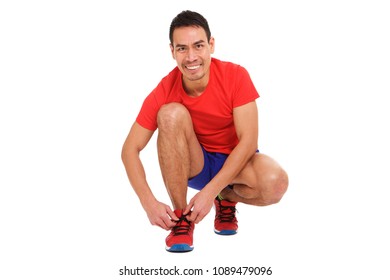 Portrait Of Asian Middle Aged Man Tying Laces Of His Sports Shoes On White Background