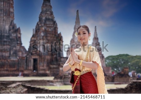 Portrait Asian model posing to pay respect with smiling wearing Thai dress traditional costume greeting  happy new year thailand songkran festival.
