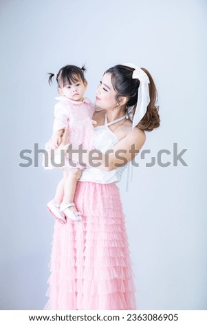 Portrait of Asian mother and child on background,