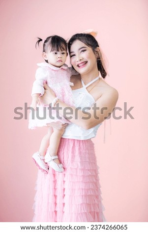 Portrait of Asian mother and child on background