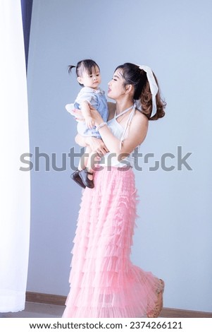 Portrait of Asian mother and child on background