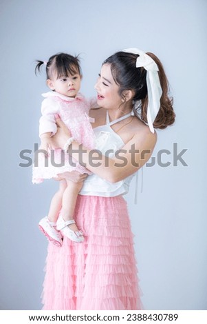 Portrait of Asian mother and child on background 
