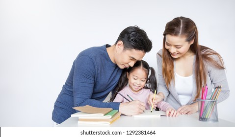 Portrait Of Asian Mother Father Teaching Daughter Learn To Write Color On Book, Asian Parents Helping Little Girl Do Homework. Education Art Work Love Together Home School Family Day Concept