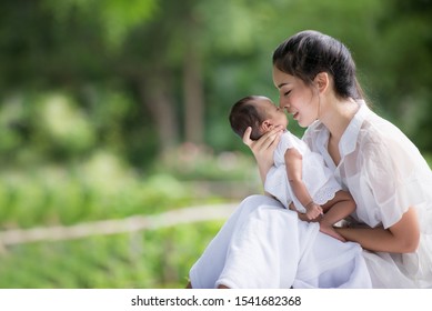 Portrait Of Asian Mother Playing With Newborn Baby, Baby Talking To Mother. Health Care Family Love Together. Asian Girl Lifestyle. Asia Mother's Day Concept