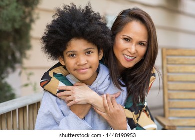 Portrait Of An Asian Mother Smiling With Her Teenage Son.