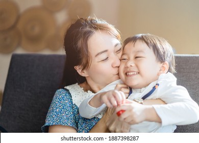 Portrait Of Asian Mother And Toddler Boy Child Playing Having Fun Together. Happy Son And Mom Laughing And Kissing At Home In Breakfast.Love Family Lifestyle Single Mom.Mother’s Day Holiday Concept.